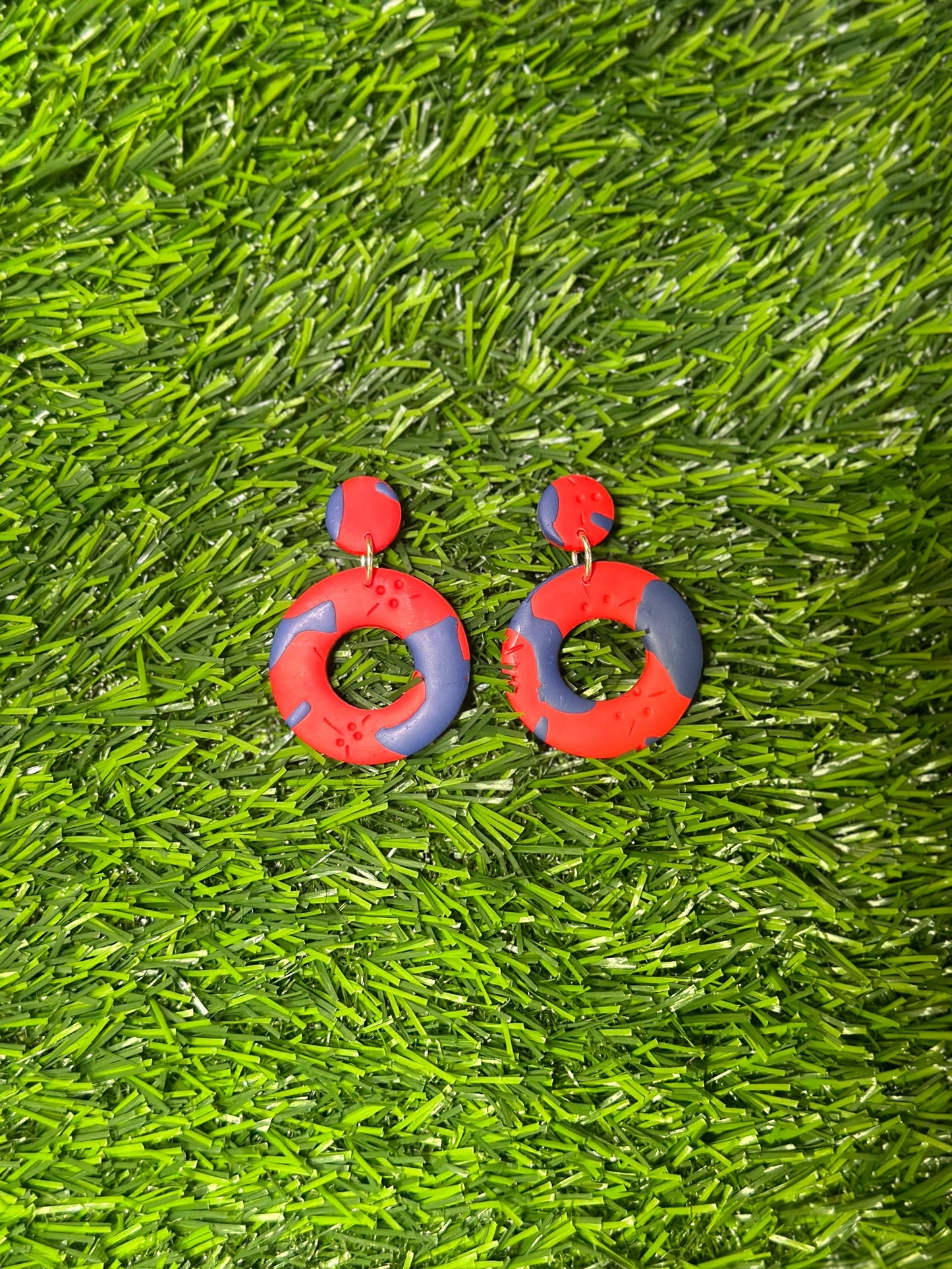 Polymer clay Bermuda earrings inspired by the shape of a cricket bal