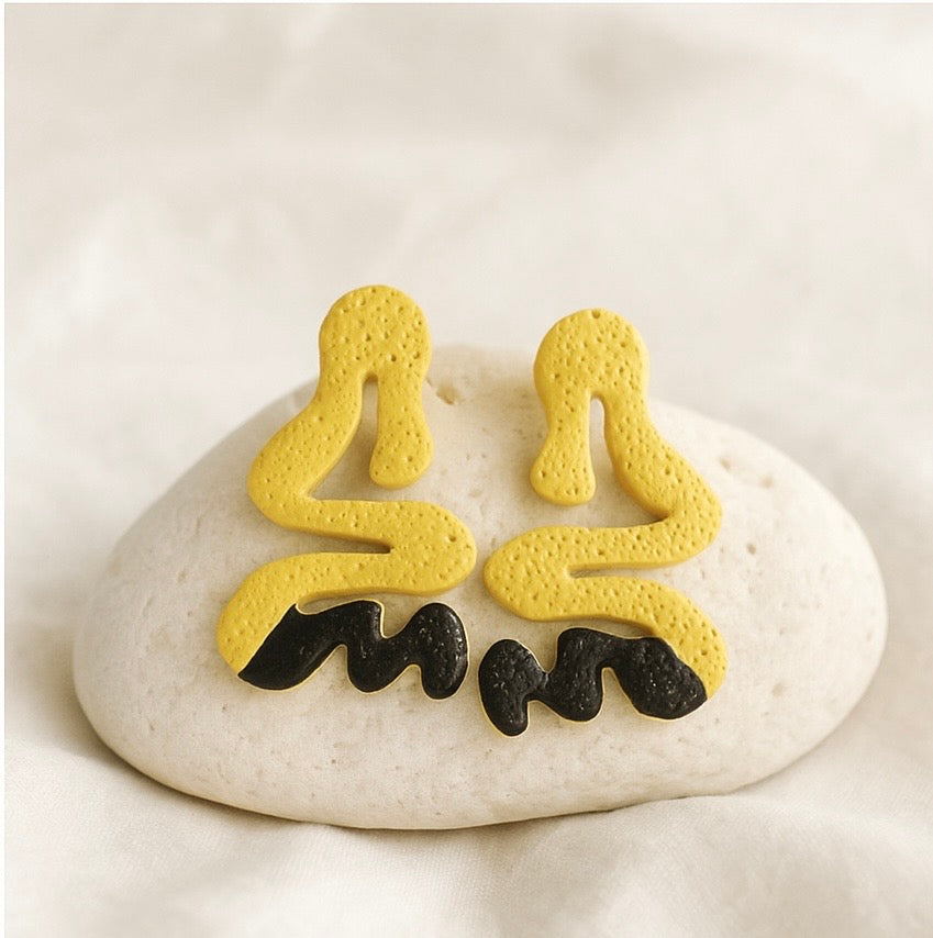 Bold Curve polymer clay stud earrings with textured swirl shape and painted stripe