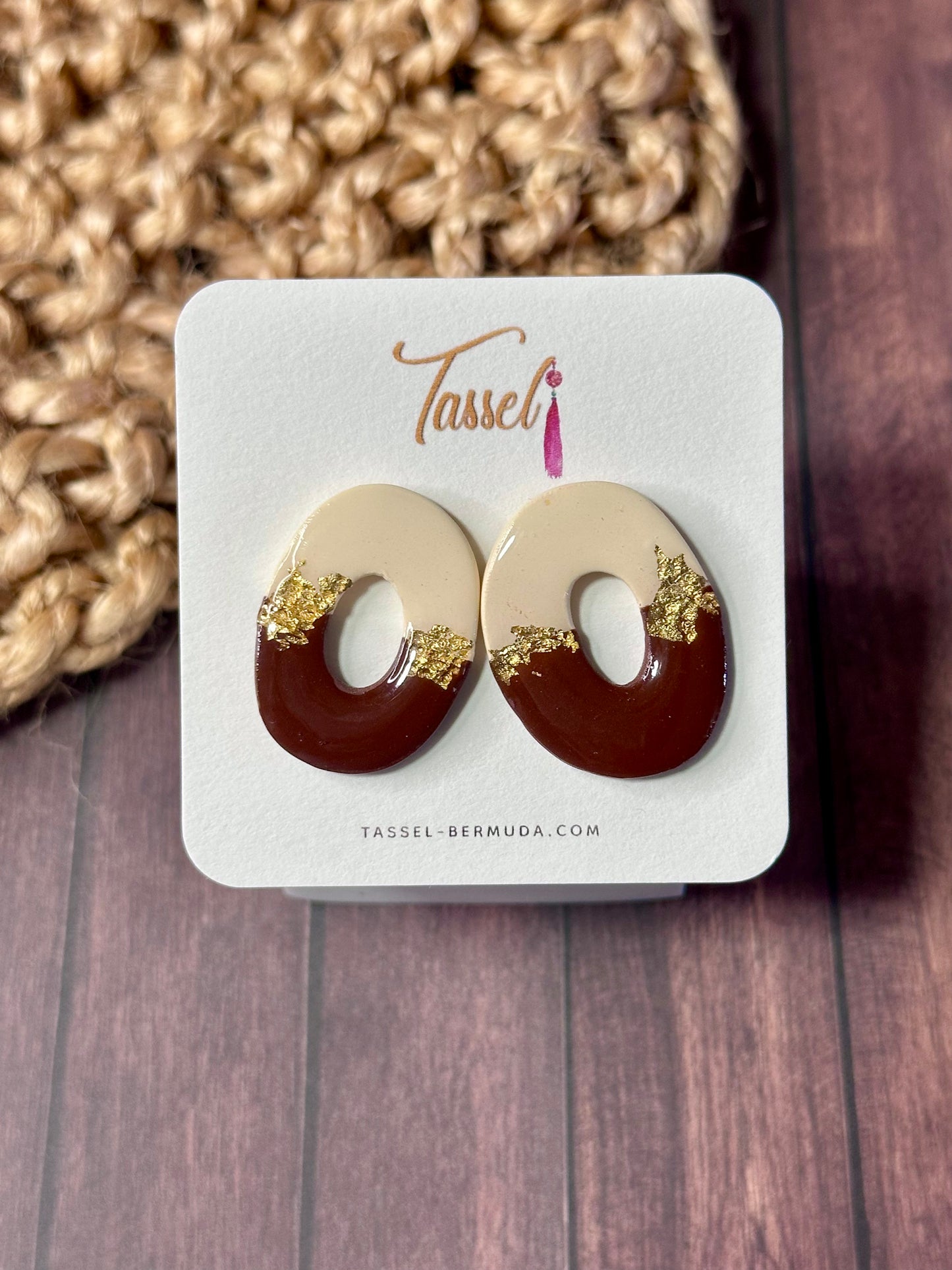 Cocoa Crème polymer clay stud earrings featuring chocolate brown and ivory tones with gold flakes and a glossy resin glaze, inspired by doughnuts.