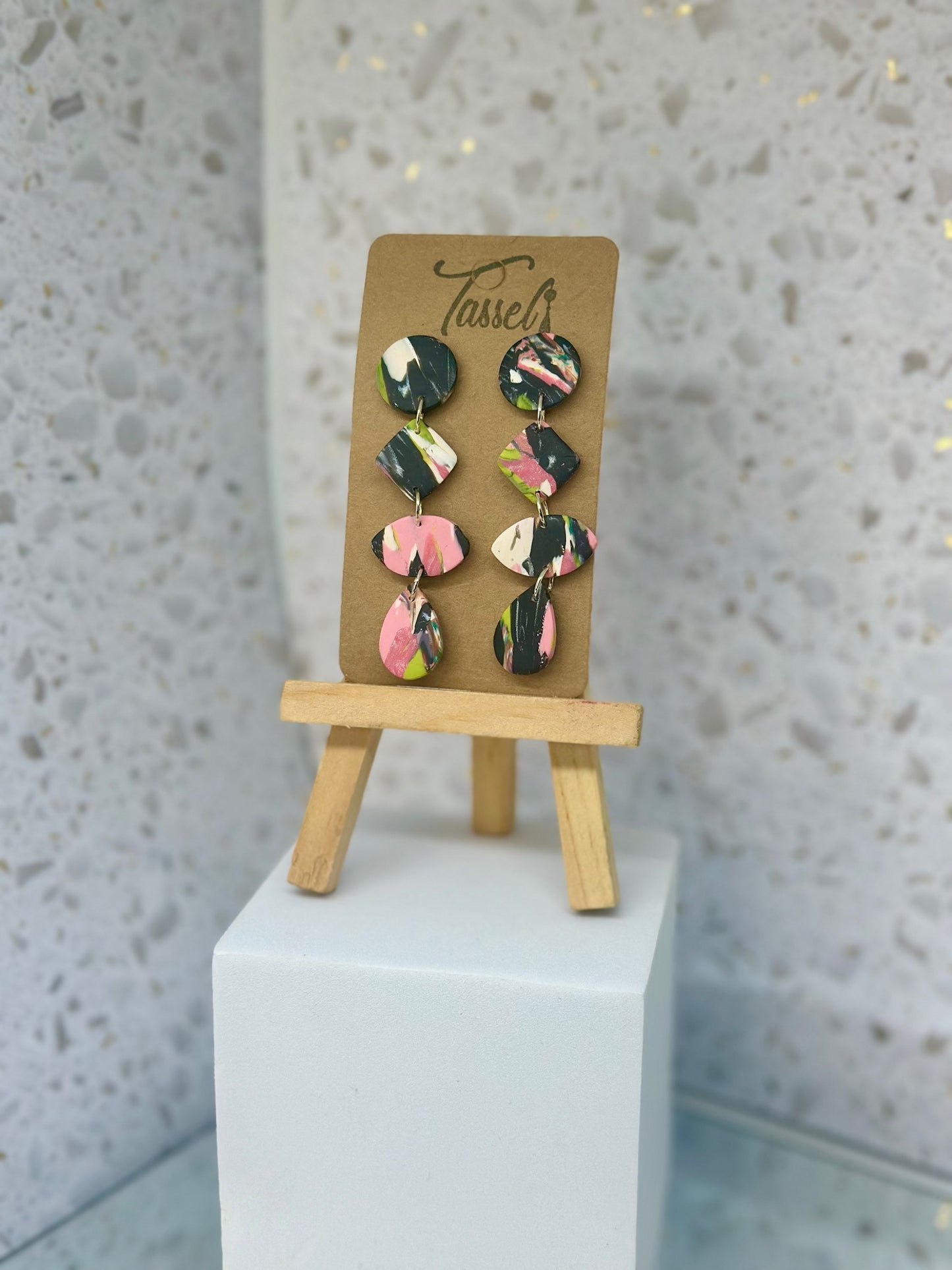 Cascading circular polymer clay dangle earrings in black, white, pink, and green