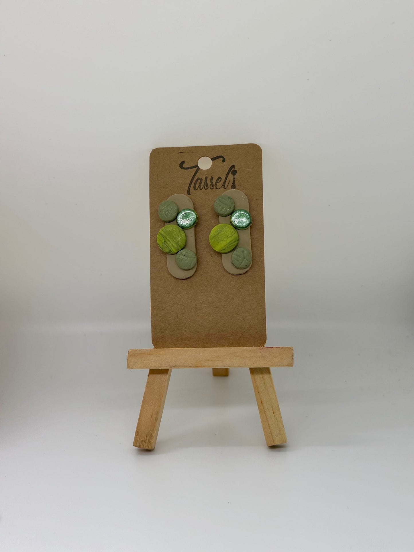 Geo Stud polymer clay earrings featuring small circular shapes with different textures and finishes, minimalist and modern.