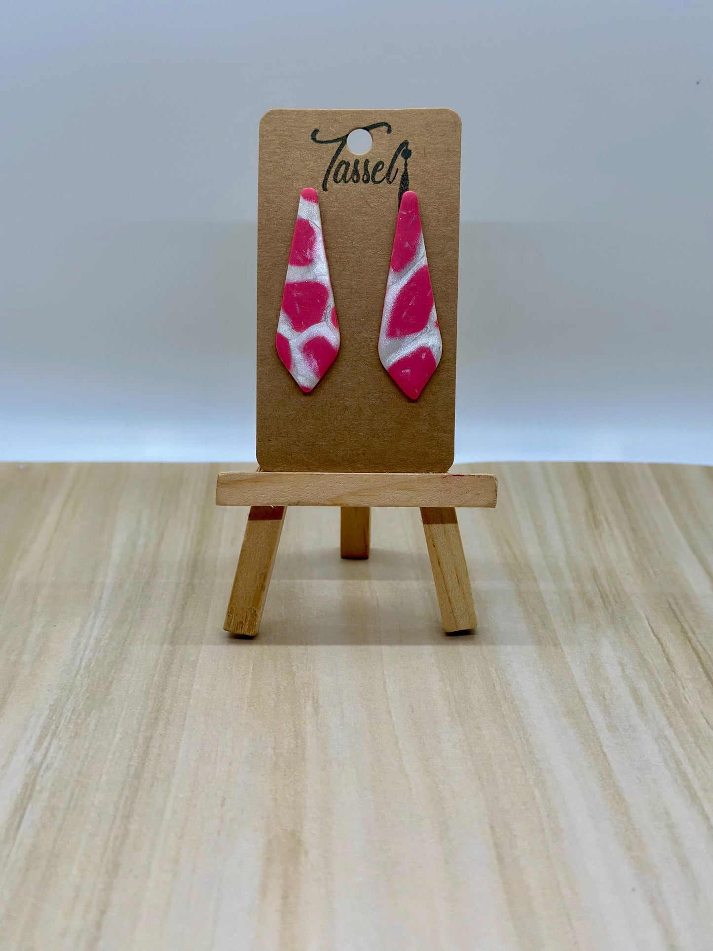 Miko polymer clay stud earrings featuring hot pink and pearl white marbled clay with shimmering finish.