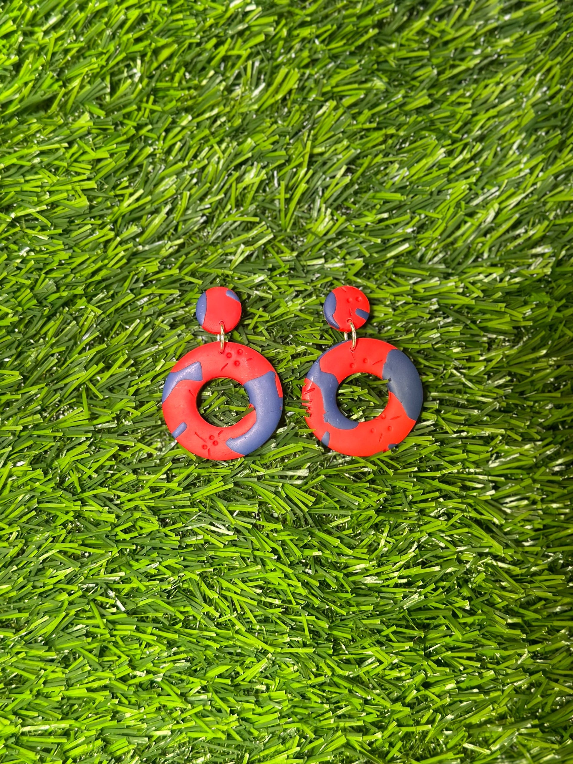 Polymer clay Bermuda earrings inspired by the shape of a cricket bal