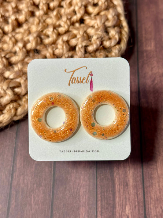 Amber Glaze stud earrings with warm amber tones and resin glaze. Handcrafted, hypoallergenic, and full of cozy charm. Shop the Glazed Collection now.