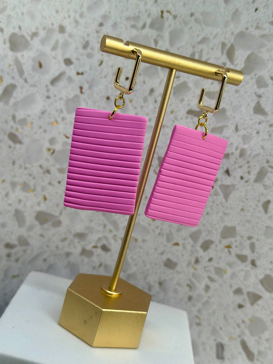 Large rectangular pink dangle earrings inspired by Bermuda cottage shutters, available in small and large sizes by Tassel Bermuda.