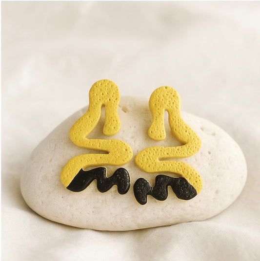 Bold Curve polymer clay stud earrings with textured swirl shape and painted stripe