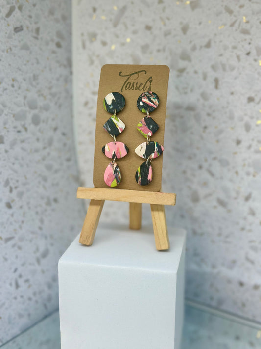 Cascading circular polymer clay dangle earrings in black, white, pink, and green
