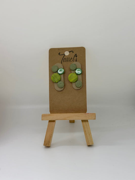 Geo Stud polymer clay earrings featuring small circular shapes with different textures and finishes, minimalist and modern.