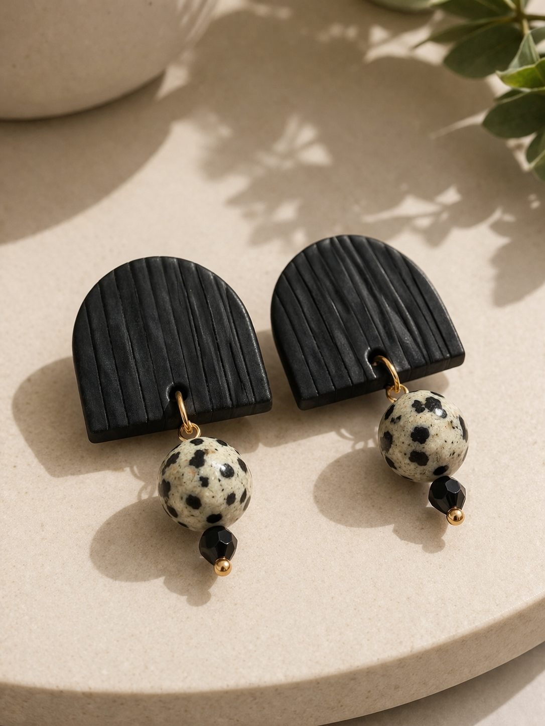 Ink & Stone polymer clay embellished stud earrings with textured black arch and speckled stone bead with gold accents