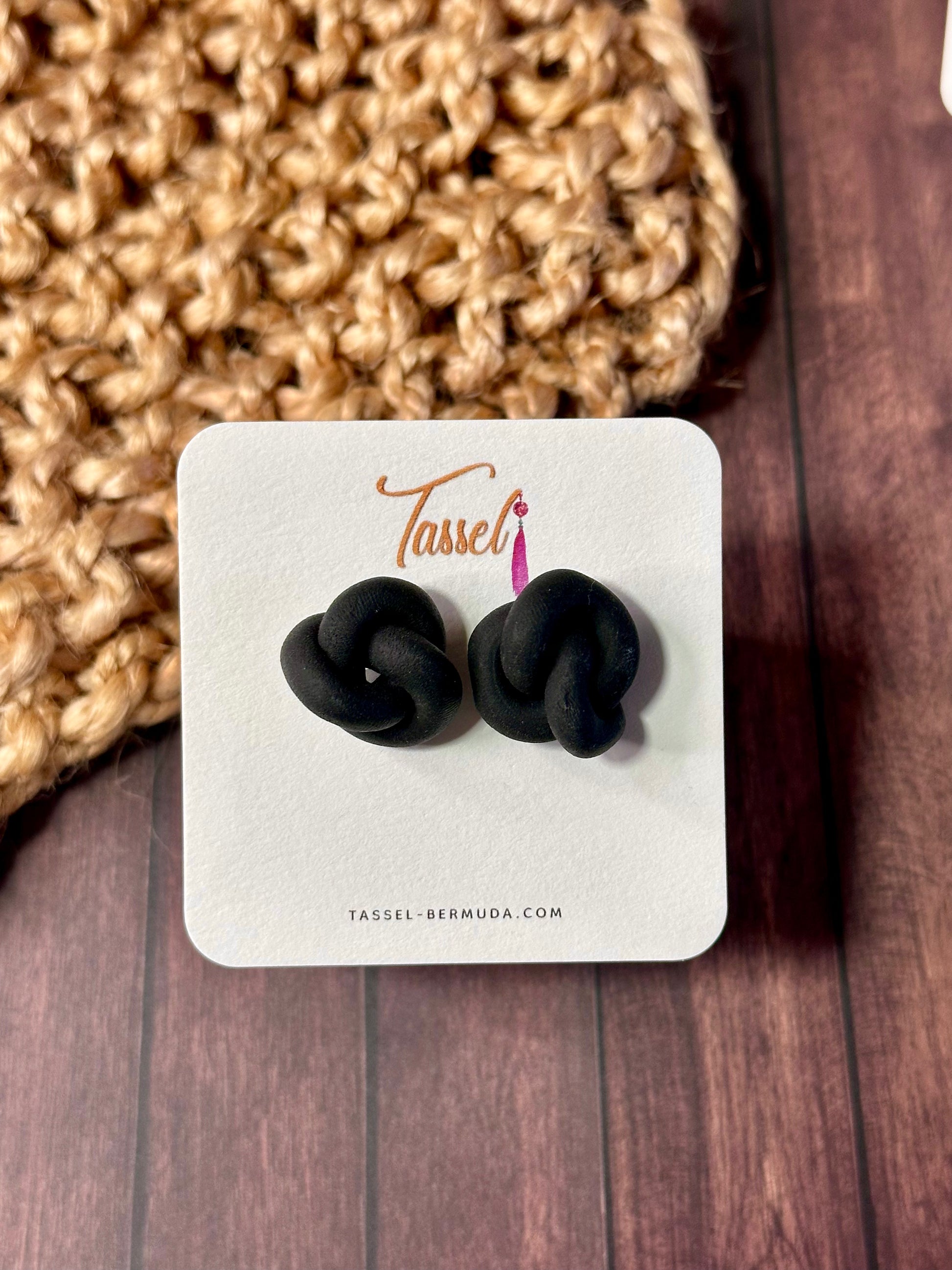 Black knot earrings on a Tassel! branded card with a textured fabric background