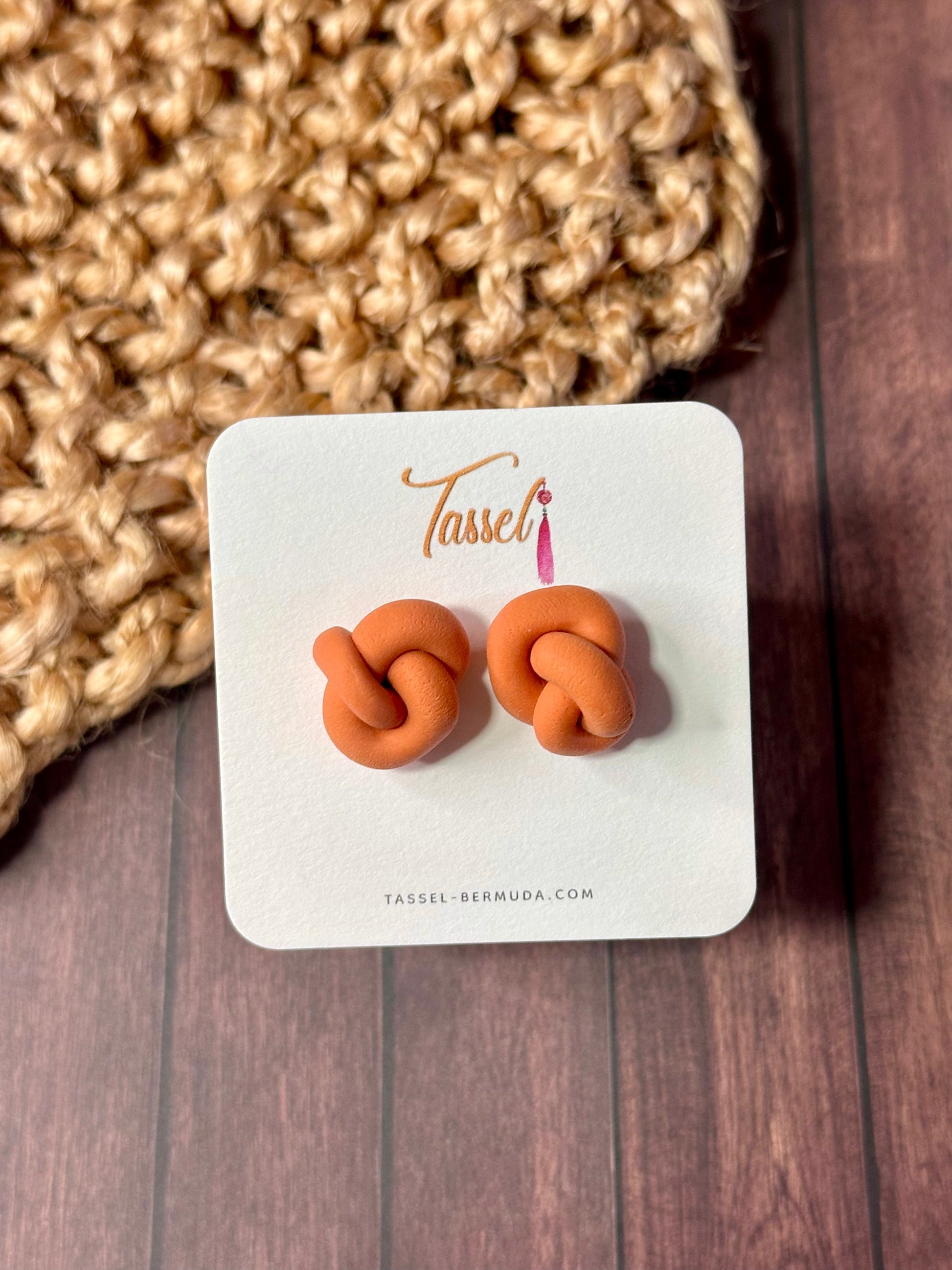 Orange Little Knots polymer clay stud earrings featuring a delicate knotted design, minimalist and lightweight for everyday elegance.