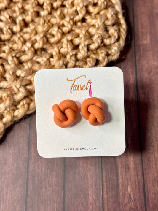 Orange Little Knots polymer clay stud earrings featuring a delicate knotted design, minimalist and lightweight for everyday elegance.