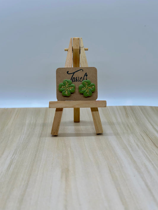 Lucky polymer clay stud earrings shaped like four-leaf clovers with shimmering gold details, perfect for St. Patrick’s Day.