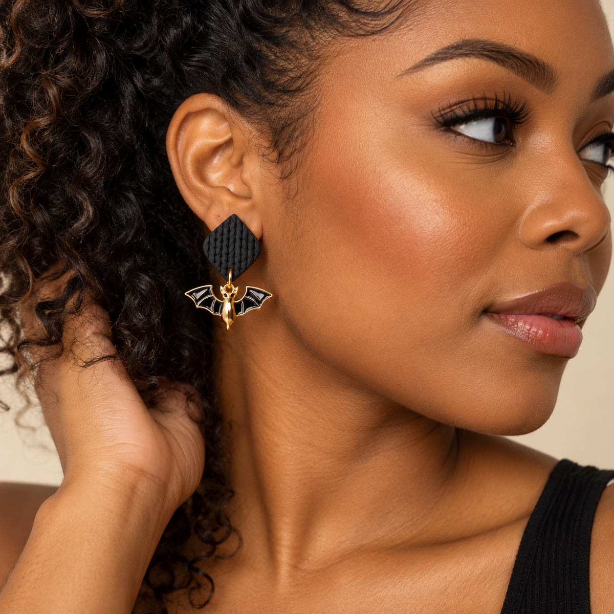 Mavis black polymer clay dangle earrings with textured tops and black and gold bat charms by Tassel Bermuda