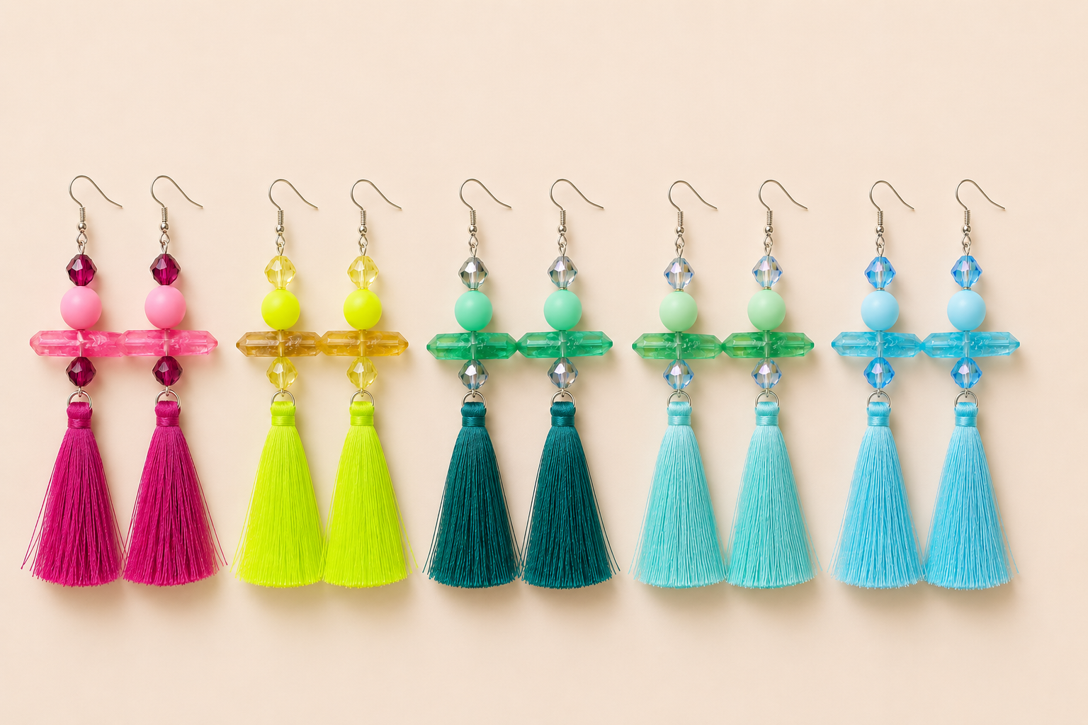 Colorful tassel dangle earrings with crystal-inspired accents in pink, yellow, green, mint, and blue by Tassel Bermuda.