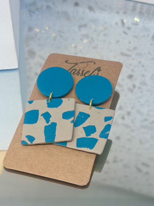 Oceana jumbo polymer clay dangle earrings featuring a turquoise blue ocean-inspired pattern with sandy tones.
