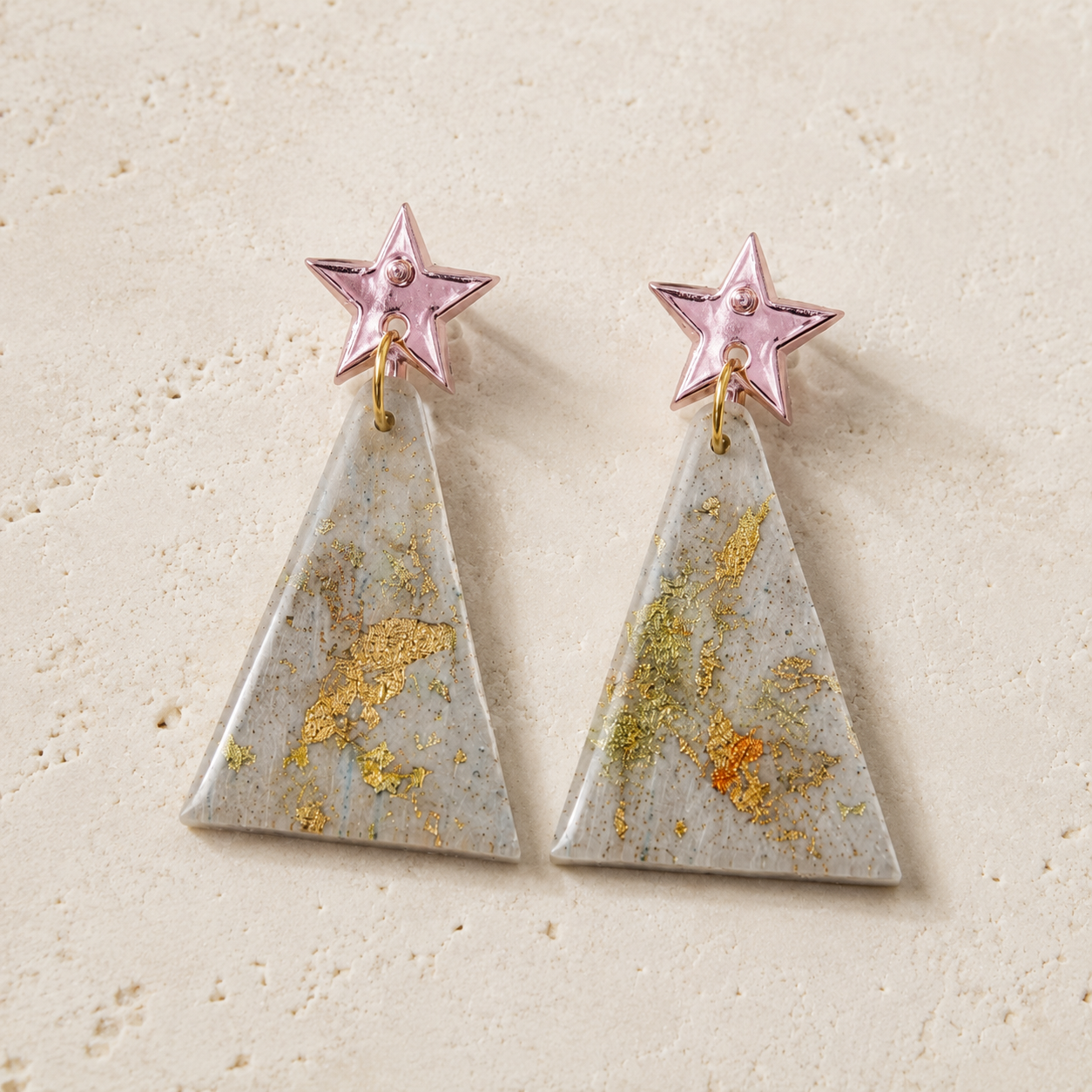 Handmade Spruce polymer clay dangle earrings with mirror star studs and gold leaf accents, available in Midnight Evergreen and Winter Frost.