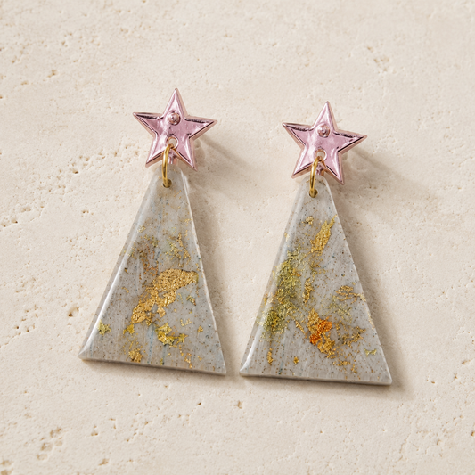 Handmade Spruce polymer clay dangle earrings with mirror star studs and gold leaf accents, available in Midnight Evergreen and Winter Frost.