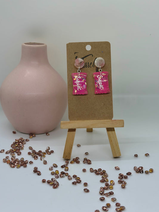 Sweet Tooth dangle earrings with a dainty pink candy bag charm, playful and lightweight design.