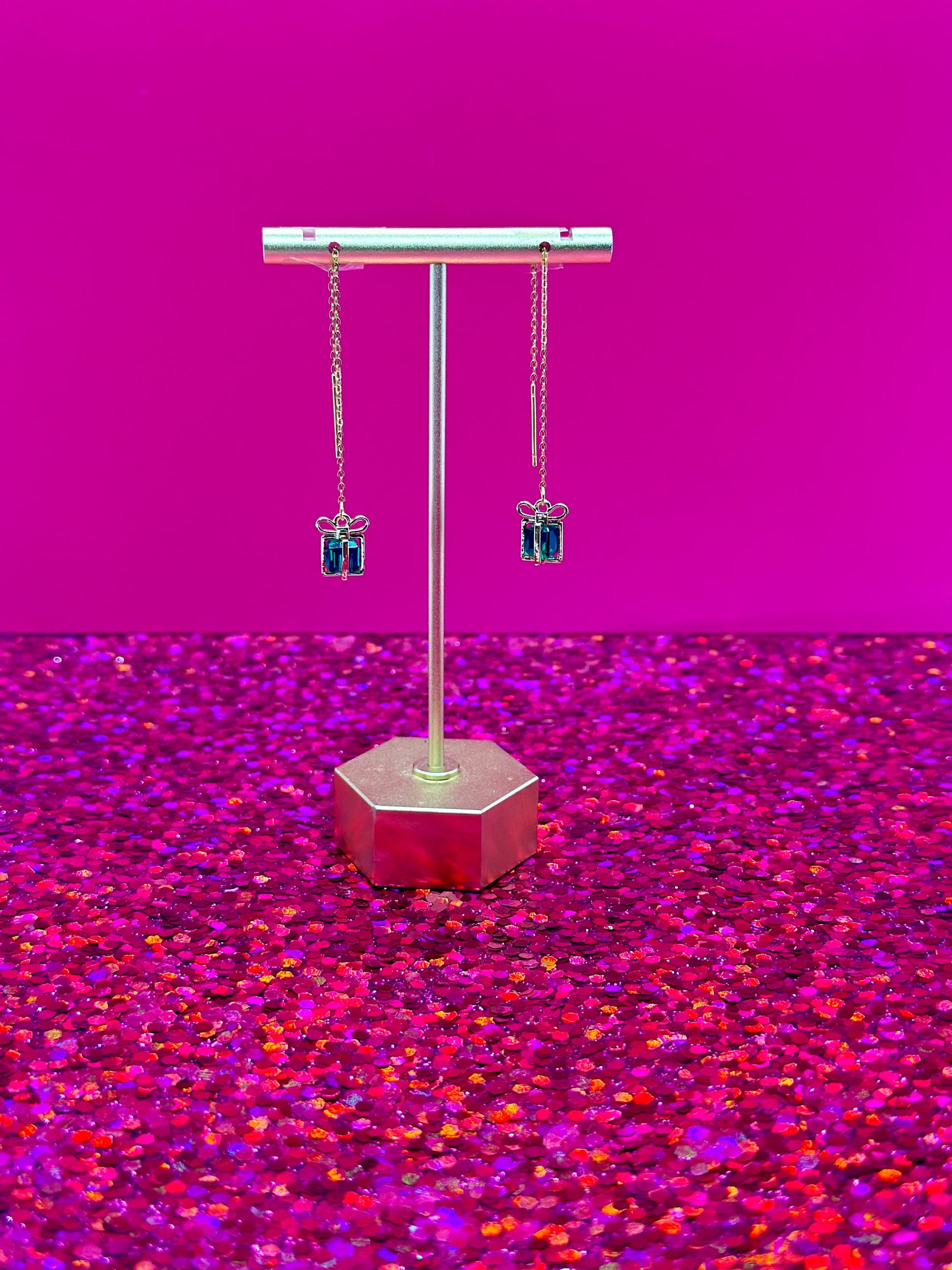 Treasure threader earrings featuring gold gift box pendants with colorful green gemstone center, designed for holidays and birthdays.