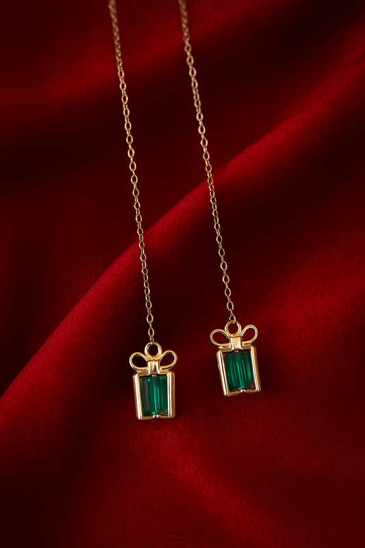 Treasure threader earrings featuring gold gift box pendants with colorful gemstone centers, designed for holidays and birthdays.