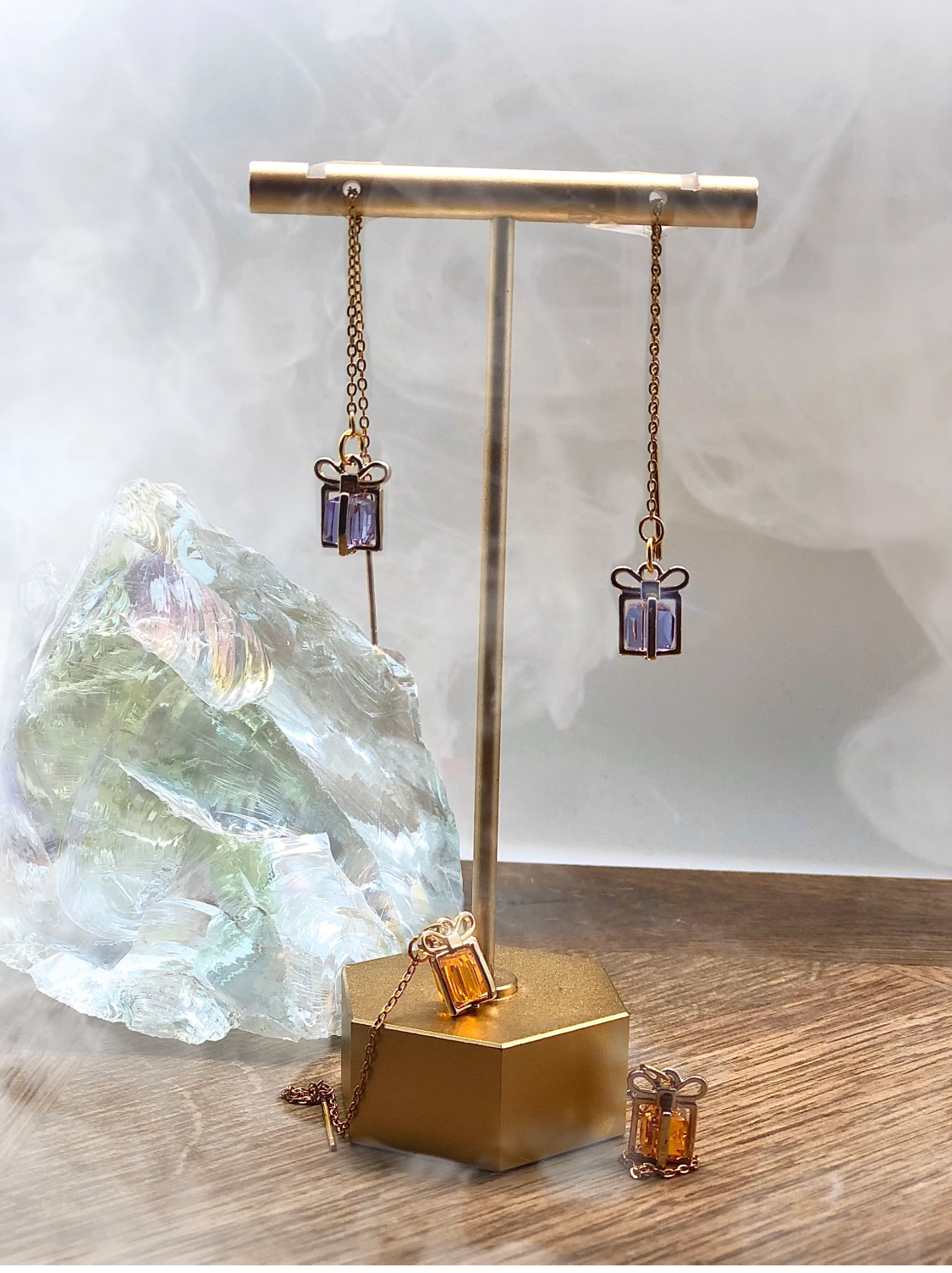 Treasure threader earrings featuring gold gift box pendants with colorful gemstone center, designed for holidays and birthdays.